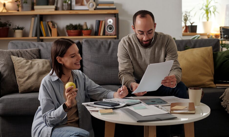 Couple reviewing property documents while planning a move to Parc Llangewydd in Bridgend
