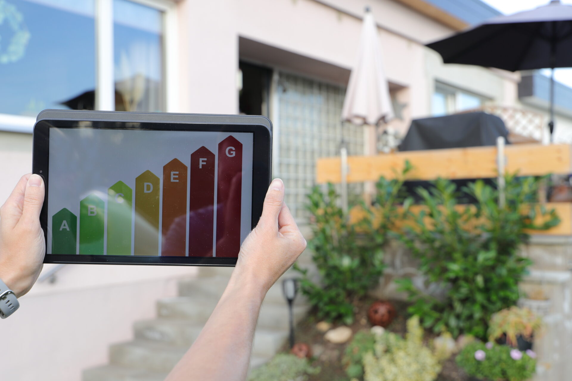 Tablet displaying EPC energy rating chart outside a rental property, showing how upgrades are increasing Bradford rents in BD8 and BD9 in 2026