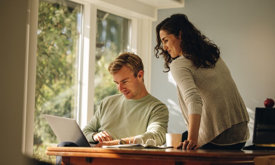 Couple researching property investment on a laptop for Bradford’s BD4 and BD5 Southern Gateway corridor in 2026