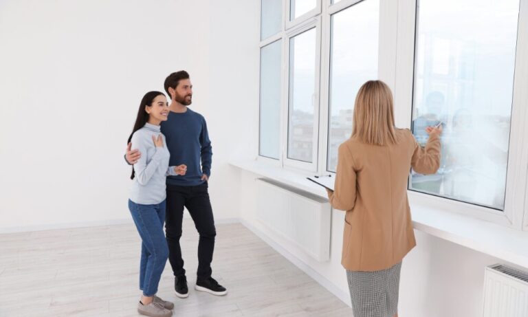 Estate agent showing a modern apartment to a couple, representing property investment and apartment demand in York’s rental market.
