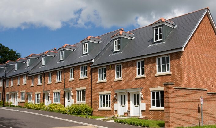 Modern UK terraced houses on a quiet residential street, reflecting the property market in 2026.